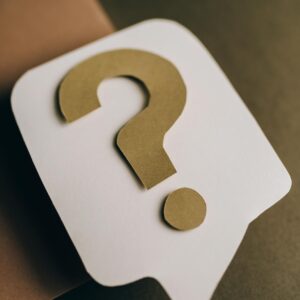 Artistic paper craft of a question mark symbol on a textured green surface. Ideal for conceptual projects.